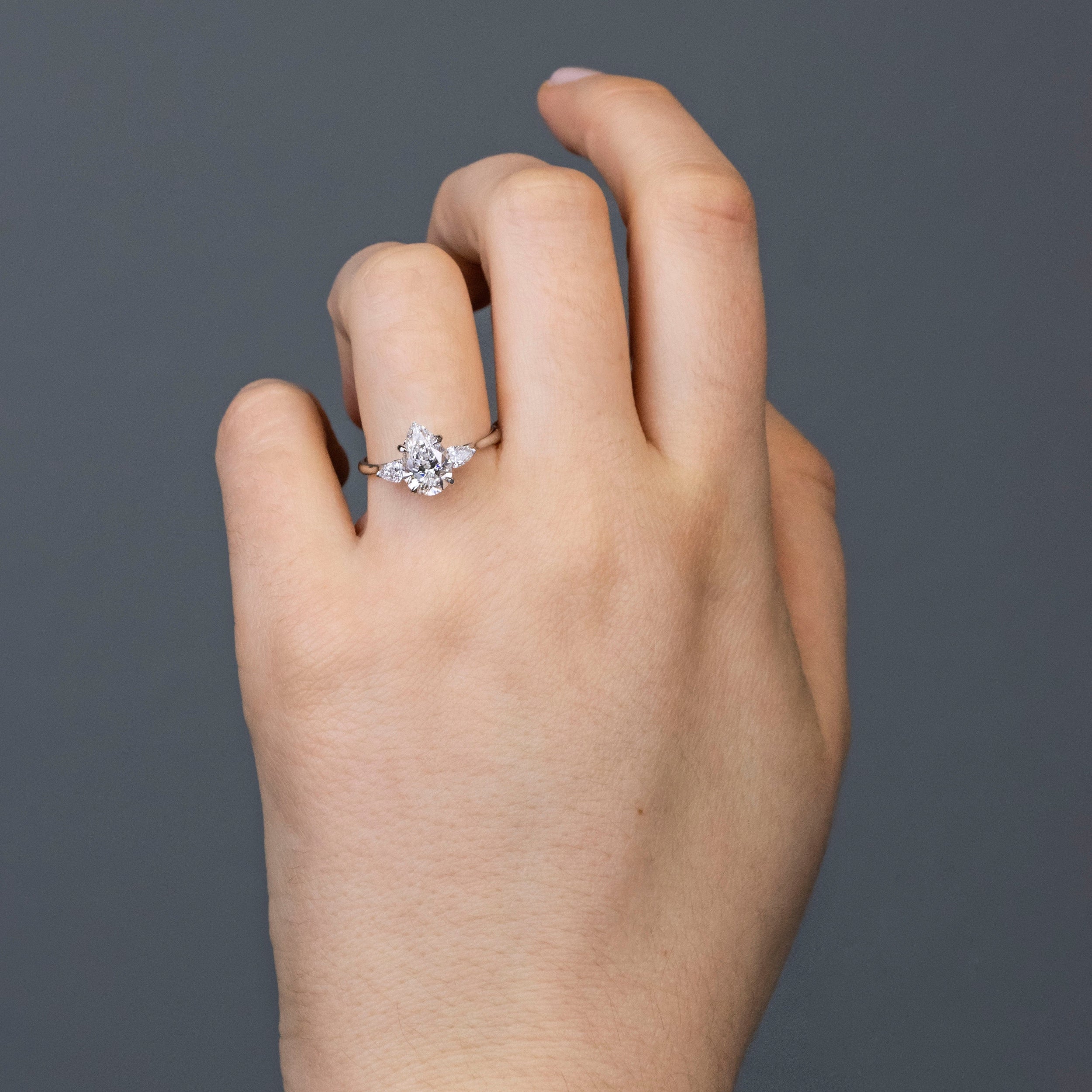 1.50 Carats Pear Shape Moissanite Three Stone Engagement Ring