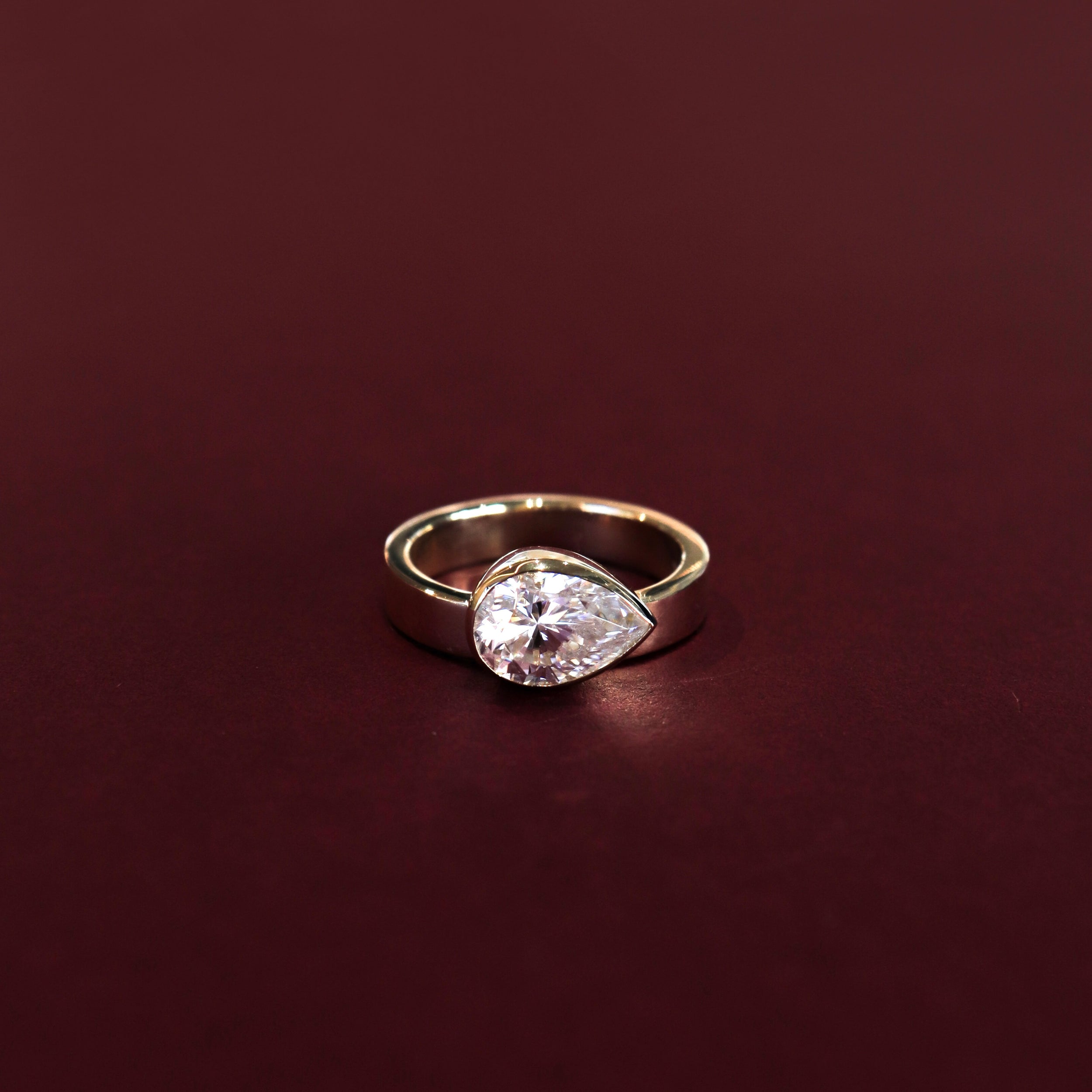 1.20 Carats East-West Pear Shape Moissanite Bezel Solitaire Engagement Ring