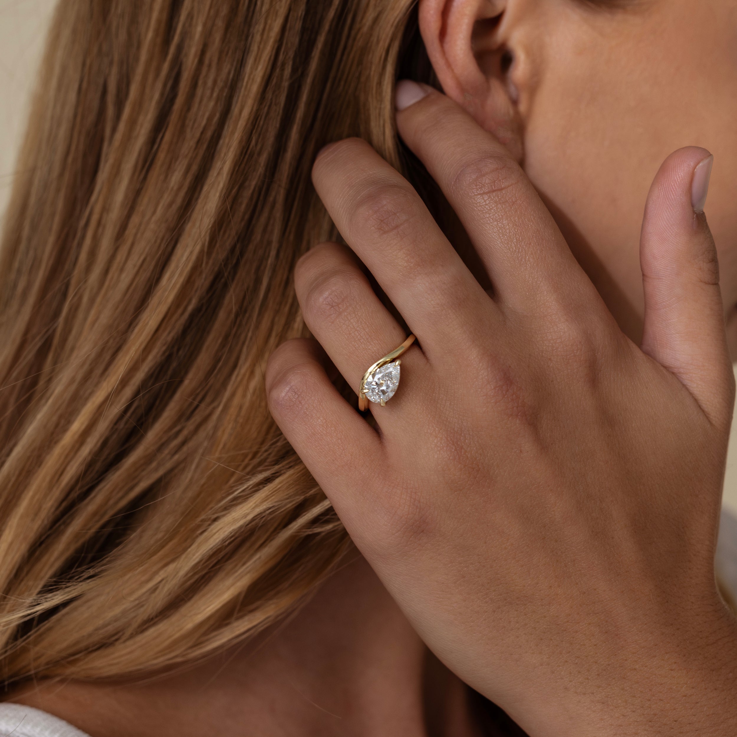 1.40 Carats East-West Pear Shape Moissanite Curved Solitaire Engagement Ring