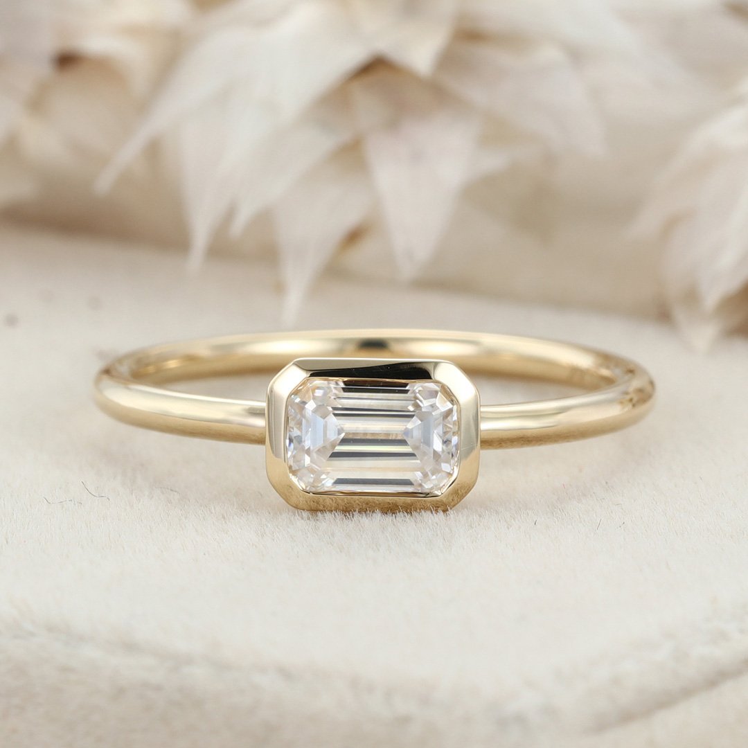 0.60 Carats East-West Emerald Shape Moissanite Bezel Solitaire Engagement Ring
