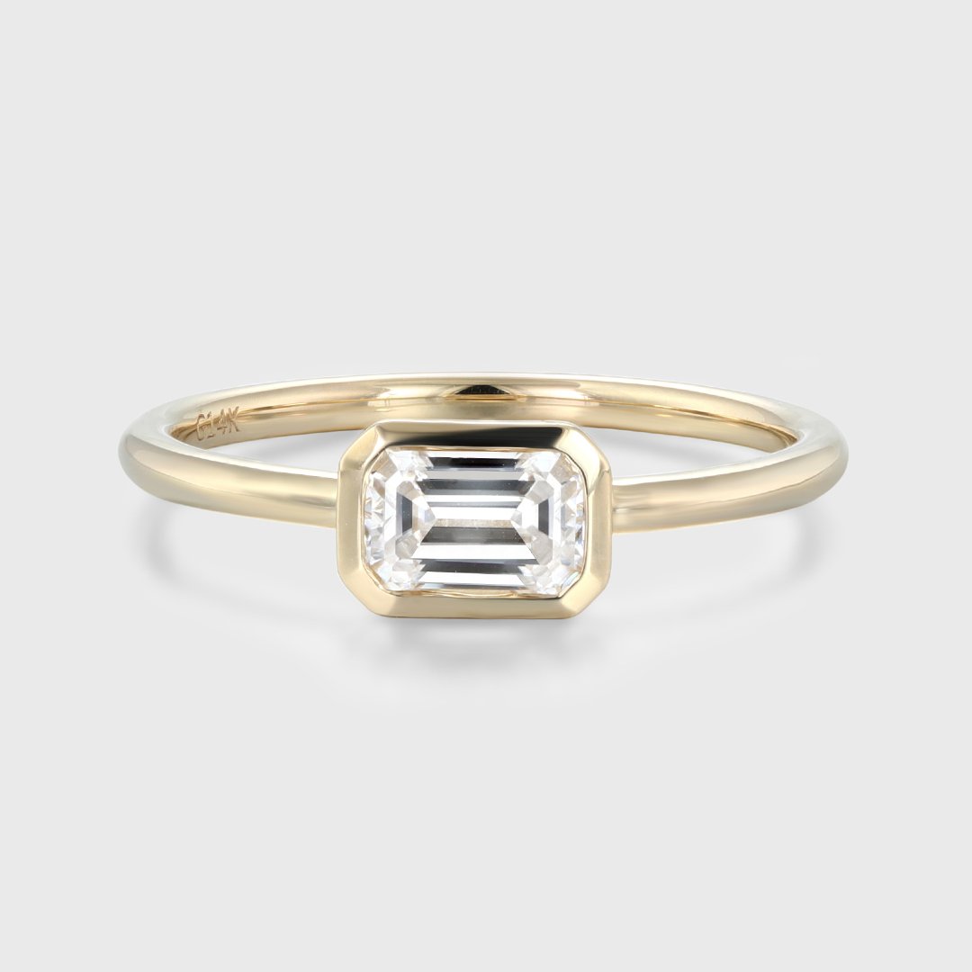 0.60 Carats East-West Emerald Shape Moissanite Bezel Solitaire Engagement Ring