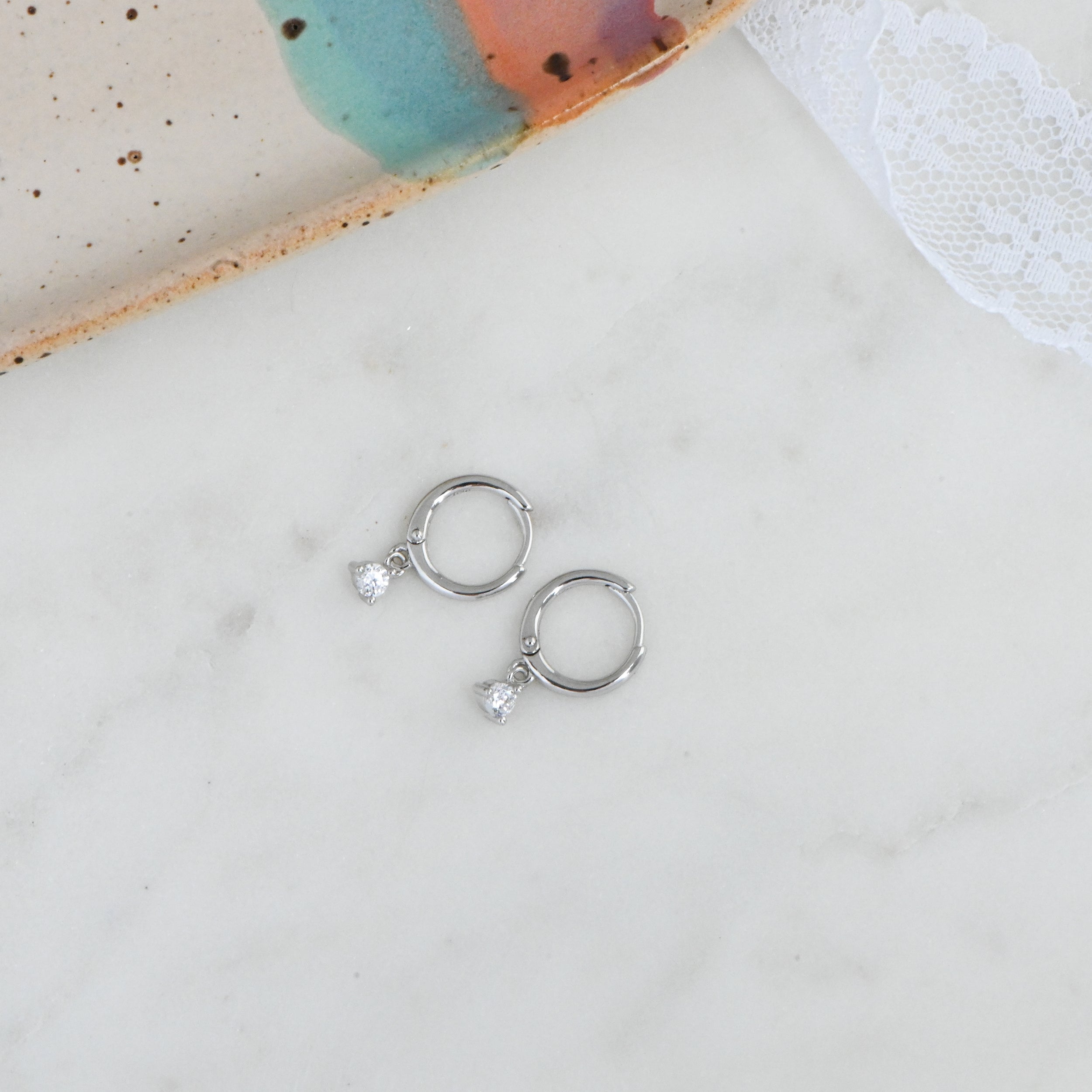 0.15 TCW Round Shape Moissanite Bezel Charm Huggies Earrings
